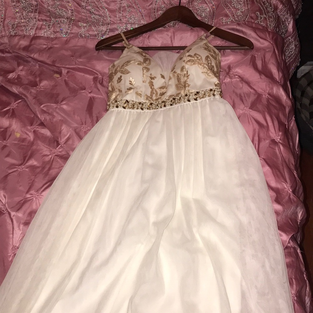 An off white long spaghetti strapped gown